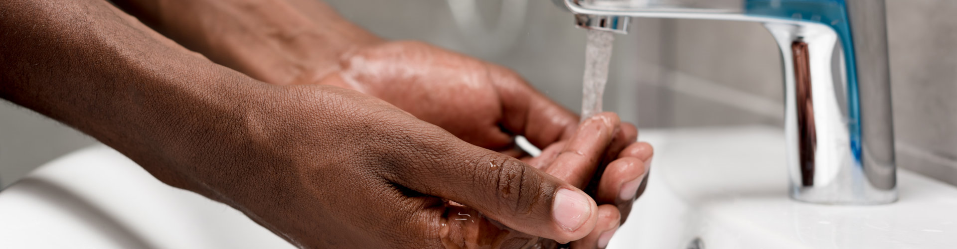close-up partial view of african american man washing in bathroom