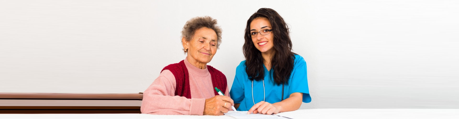 a caregiver woman interviewing an elderly woman